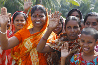 Women and children smiling and waving